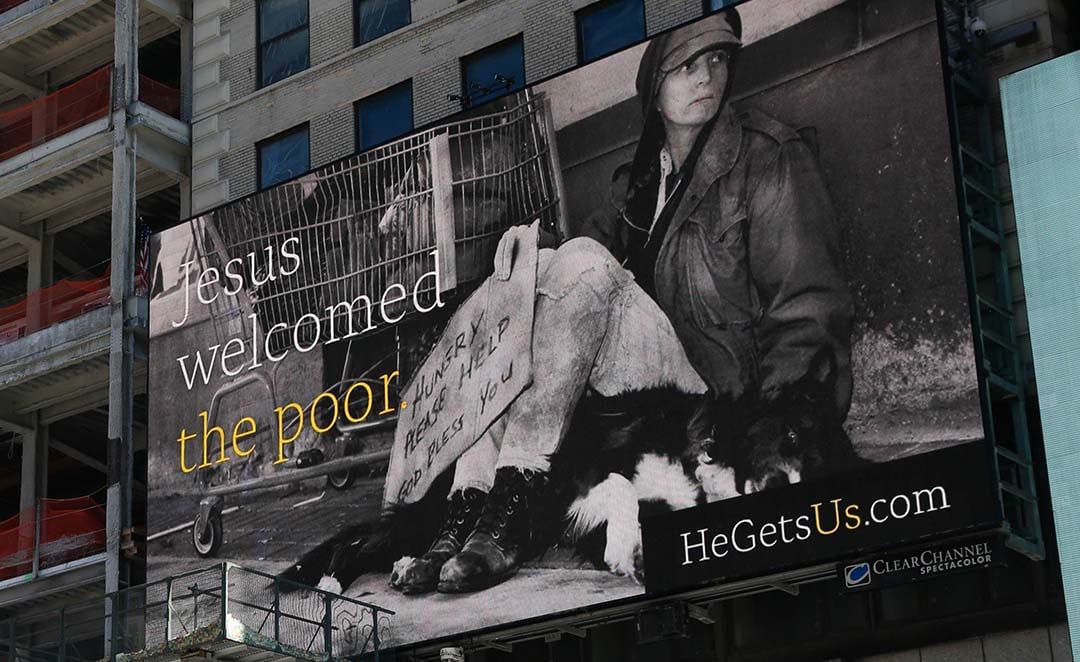 He Gets Us billboard reading Jesus welcomed the poor on a city building.